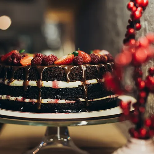 aQ ppetizing-chocolate-cake-on-cake-stand-and-twigs-2024-11-08-14-43-19-utc
