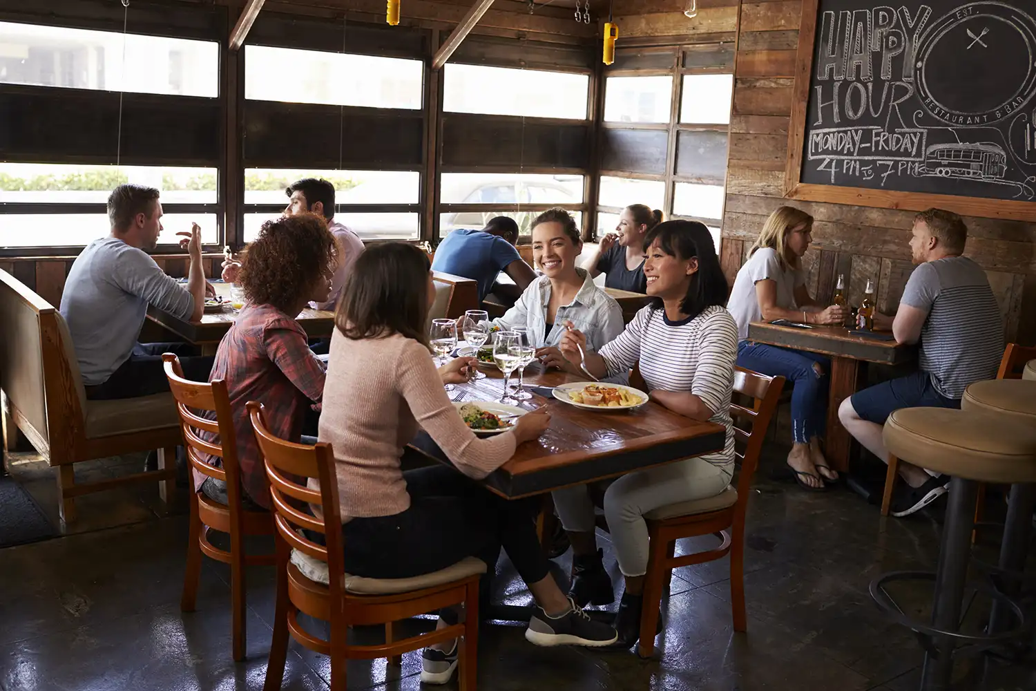 four-female-friends-at-lunch-in-busy-restaurant-f-2024-10-19-10-47-34-utc